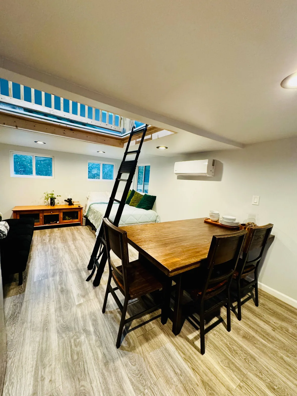 The kitchen, with an electric stove, microwave and open shelving