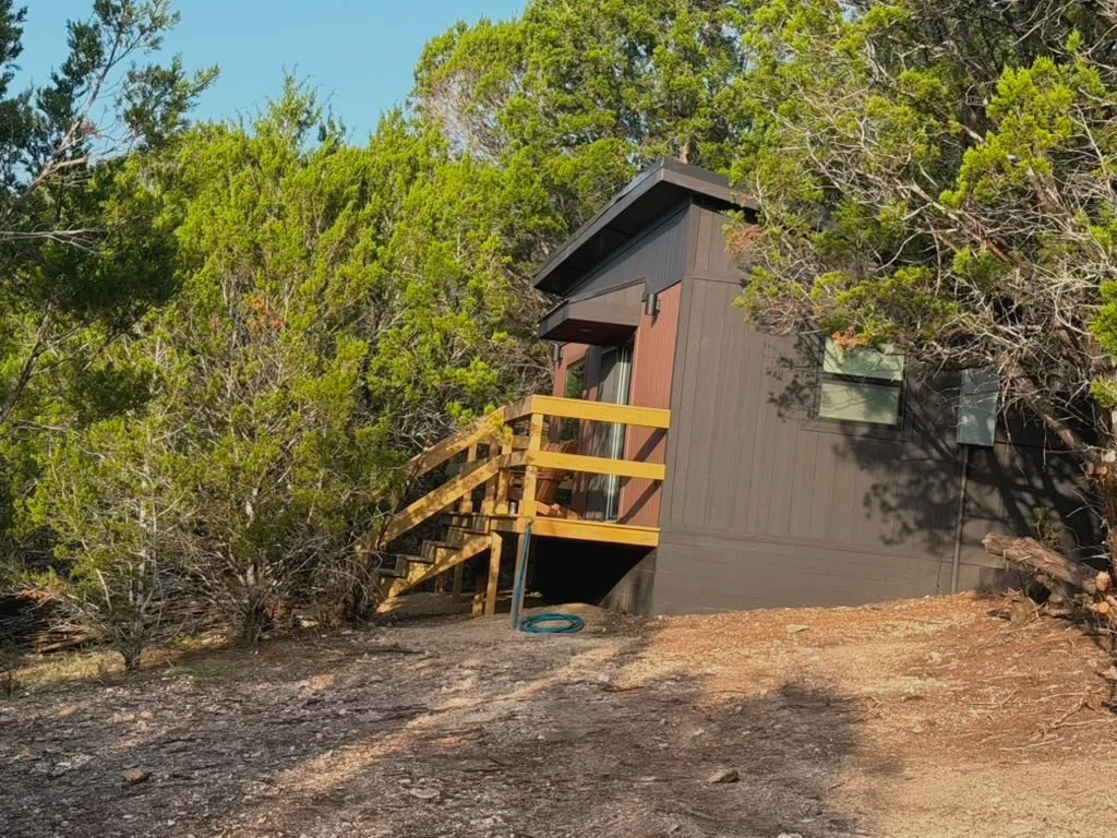 Casita 3 under its black shed roof, with wooden steps up to the deck
